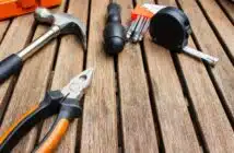 assorted-type carpentry tools on brown surface